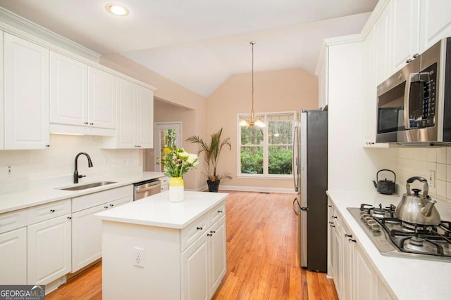 4236 Providence Ln, Tucker, GA 30084 - kitchen with white cabinetry, a sink, appliances with stainless steel finishes, and vaulted ceiling