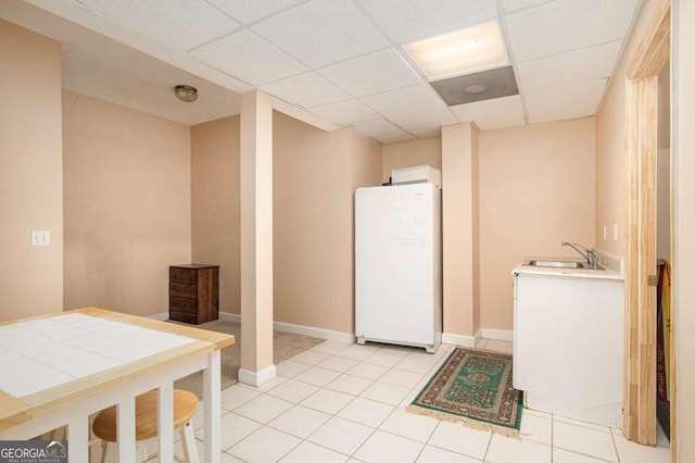 4236 Providence Ln, Tucker, GA 30084 - kitchen with light countertops, light tile patterned floors, a sink, freestanding refrigerator, and a paneled ceiling