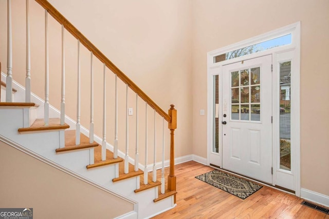 4236 Providence Ln, Tucker, GA 30084 - foyer entrance with baseboards, visible vents, wood finished floors, and stairway
