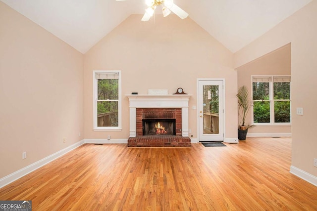 4236 Providence Ln, Tucker, GA 30084 - unfurnished living room featuring high vaulted ceiling, a brick fireplace, baseboards, wood finished floors, and a ceiling fan