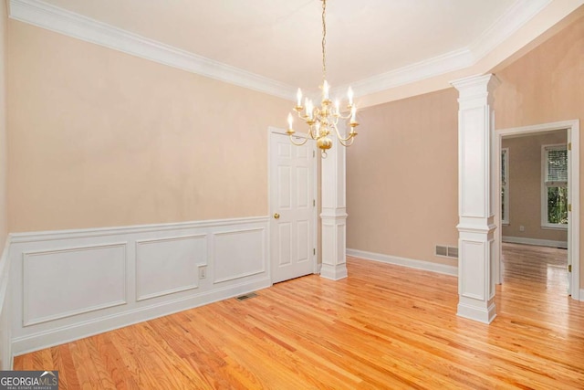 4236 Providence Ln, Tucker, GA 30084 - spare room with ornate columns, light wood-style floors, ornamental molding, and a chandelier