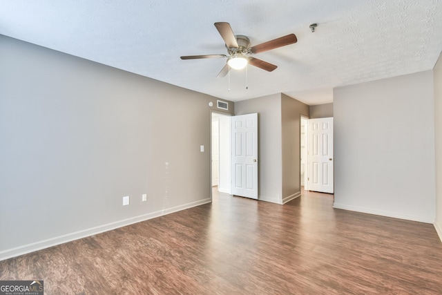 unfurnished bedroom with a textured ceiling, visible vents, baseboards, ceiling fan, and wood finished floors