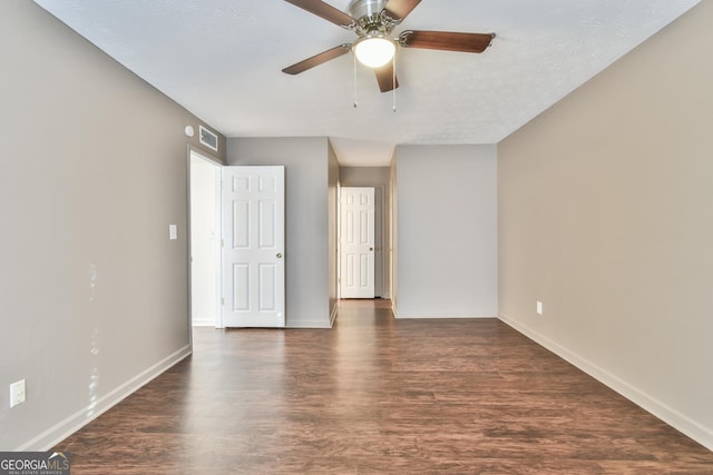 interior space with baseboards, visible vents, wood finished floors, and ceiling fan