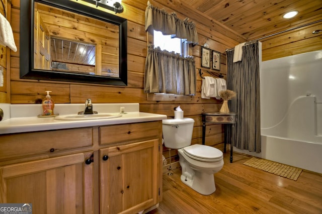 full bath with toilet, wood finished floors, wooden walls, and wooden ceiling