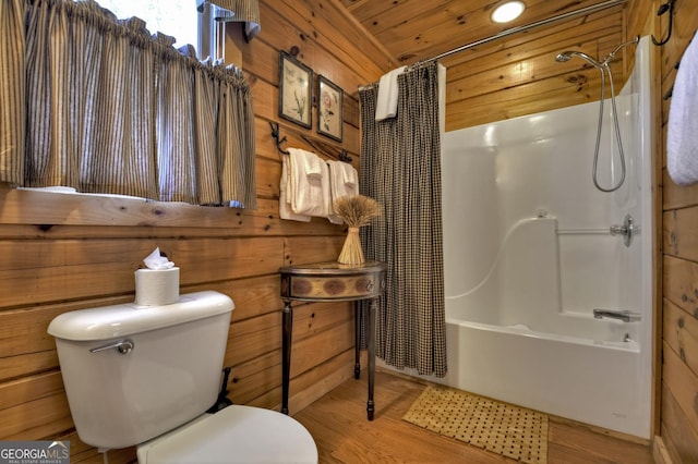 bathroom featuring toilet, shower / tub combo with curtain, wood ceiling, wooden walls, and wood finished floors