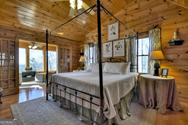 bedroom featuring wooden walls, wood finished floors, and wood ceiling