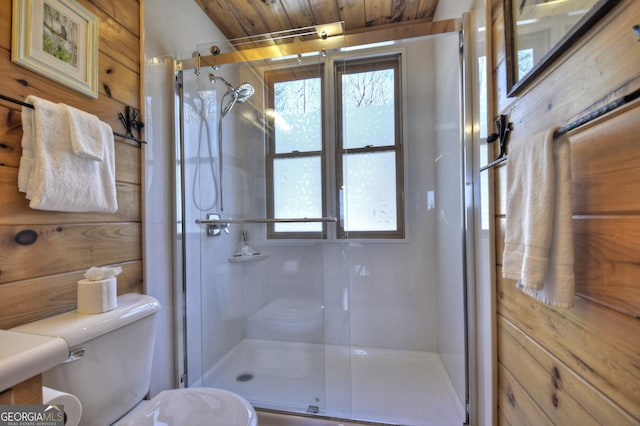 full bathroom featuring toilet and a shower stall