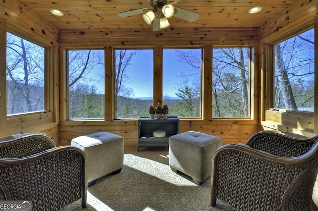 sunroom with wooden ceiling, wooden walls, and plenty of natural light