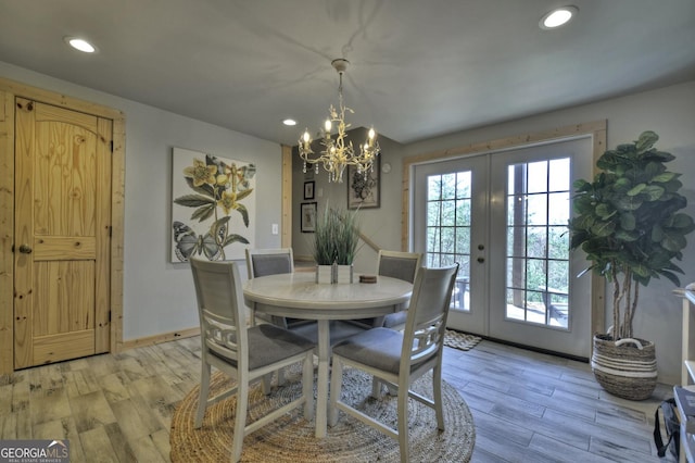 dining space with recessed lighting, french doors, a chandelier, and light wood-type flooring