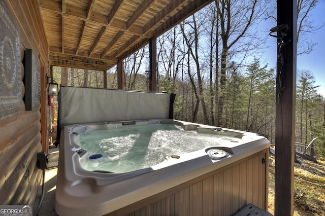 wooden terrace featuring a hot tub