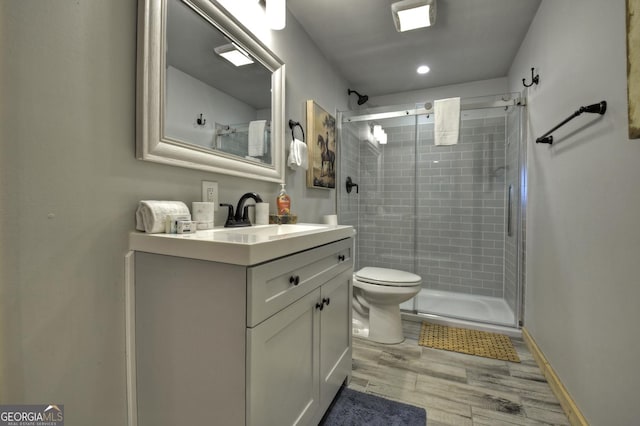 54 Channing Holw, Morganton, GA 30560 - full bathroom featuring wood finished floors, toilet, a stall shower, and vanity
