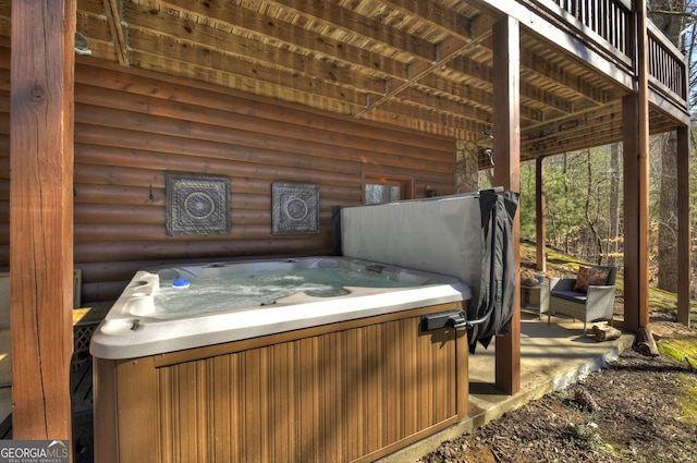 wooden terrace with a hot tub