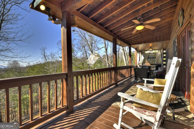 wooden terrace featuring a ceiling fan