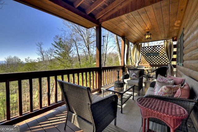 wooden terrace with outdoor lounge area