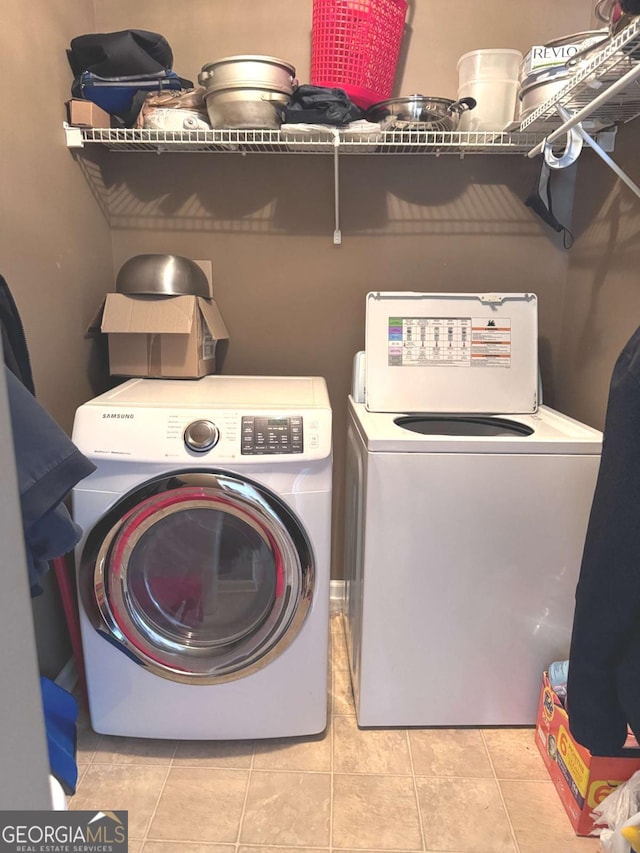 laundry area featuring independent washer and dryer and tile patterned flooring