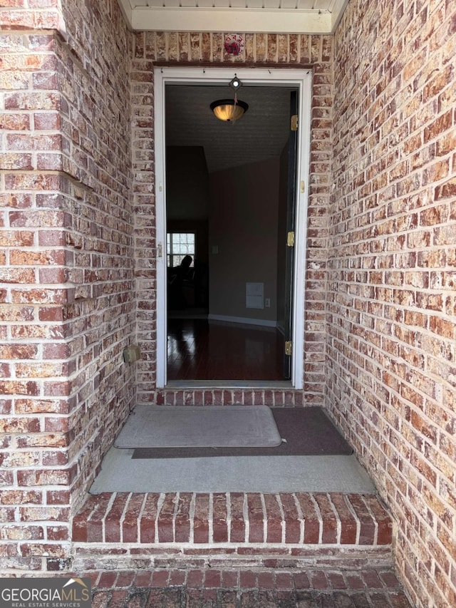 entrance to property with brick siding