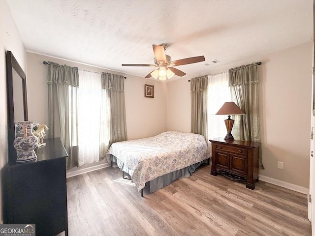 2985 Catalina Dr, Decatur, GA 30032 - bedroom featuring baseboards, multiple windows, visible vents, and light wood-style floors
