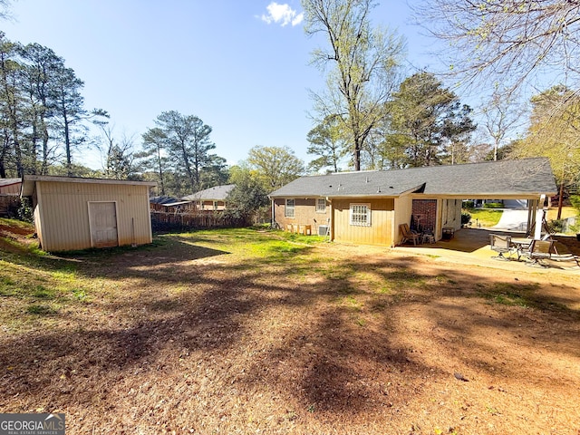 2985 Catalina Dr, Decatur, GA 30032 - view of yard featuring fence, a storage shed, an outdoor structure, and a carport