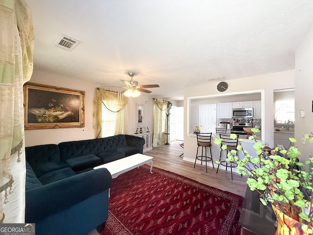 2985 Catalina Dr, Decatur, GA 30032 - living room featuring visible vents, wood finished floors, and a ceiling fan