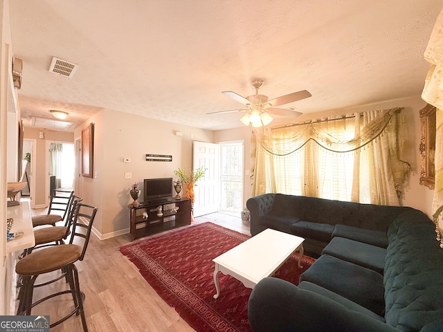 2985 Catalina Dr, Decatur, GA 30032 - living area featuring baseboards, a textured ceiling, ceiling fan, light wood-style flooring, and visible vents