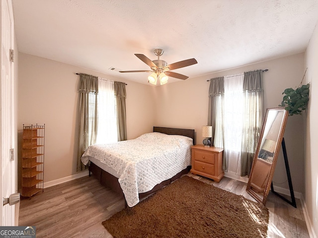 2985 Catalina Dr, Decatur, GA 30032 - bedroom featuring a ceiling fan, light wood-style flooring, baseboards, and a textured ceiling
