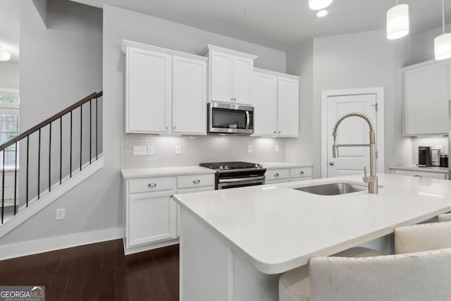 5726 Taylor Way, Sandy Springs, GA 30342 - kitchen with appliances with stainless steel finishes, dark wood-style flooring, tasteful backsplash, light countertops, and white cabinetry