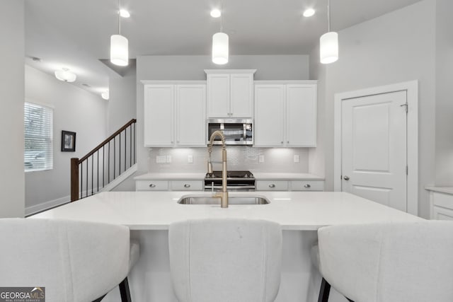 5726 Taylor Way, Sandy Springs, GA 30342 - kitchen featuring stainless steel appliances, decorative backsplash, white cabinetry, and pendant lighting