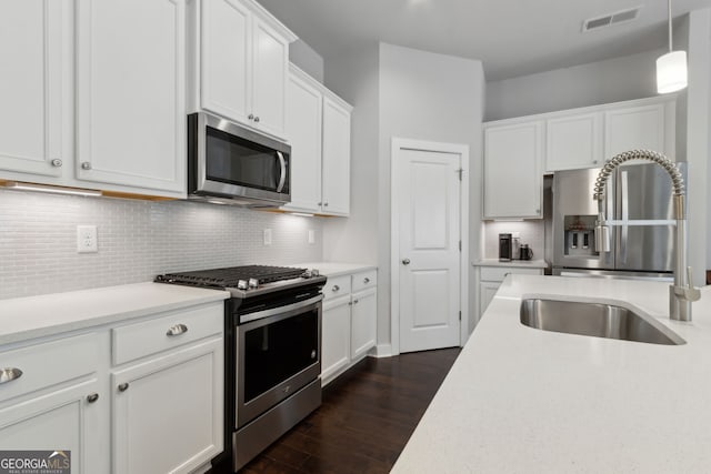 5726 Taylor Way, Sandy Springs, GA 30342 - kitchen featuring stainless steel appliances, dark wood-style flooring, white cabinetry, light countertops, and tasteful backsplash