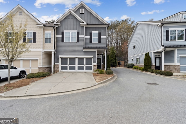 5726 Taylor Way, Sandy Springs, GA 30342 - view of front facade with concrete driveway, board and batten siding, brick siding, and an attached garage