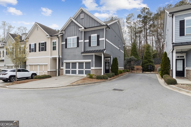5726 Taylor Way, Sandy Springs, GA 30342 - view of front of property featuring board and batten siding, concrete driveway, brick siding, and a garage