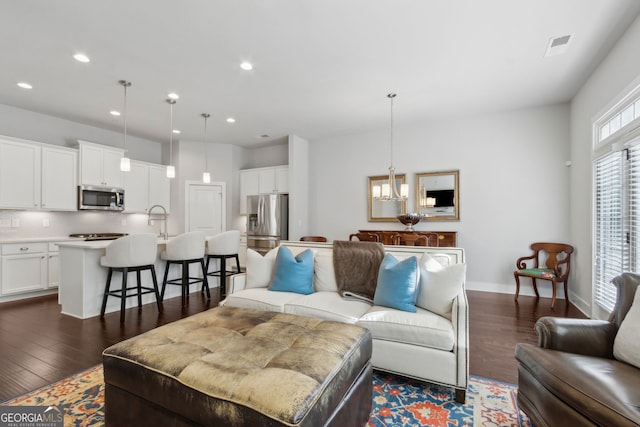 5726 Taylor Way, Sandy Springs, GA 30342 - living area featuring dark wood-type flooring, recessed lighting, and a chandelier