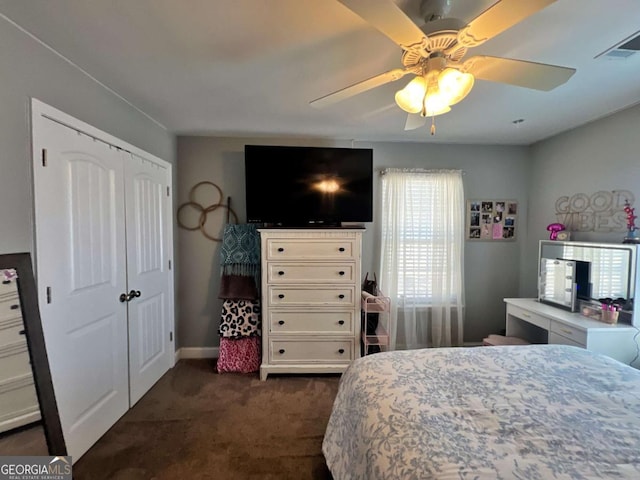 bedroom featuring a closet, ceiling fan, visible vents, carpet, and baseboards