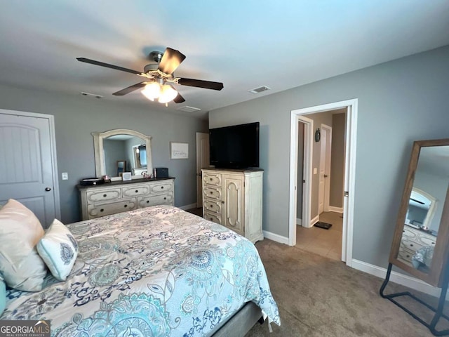bedroom with light colored carpet, visible vents, a ceiling fan, and baseboards