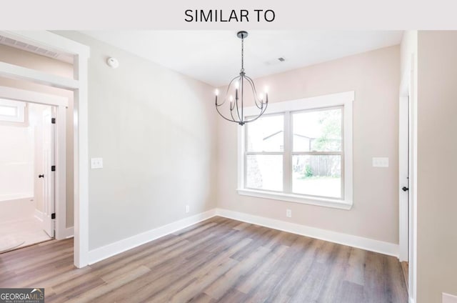 107 Tilden Way, Perry, GA 31069 - spare room with wood finished floors, a chandelier, and a smoke detector