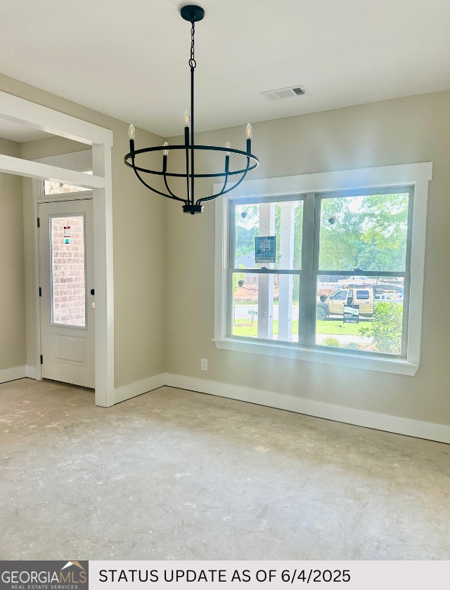 107 Tilden Way, Perry, GA 31069 - empty room with plenty of natural light, a chandelier, and concrete flooring