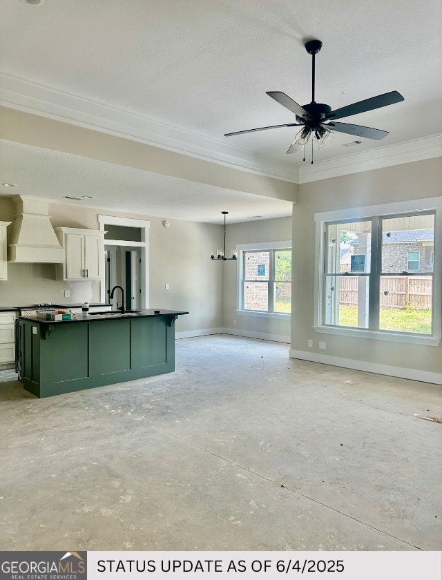 107 Tilden Way, Perry, GA 31069 - kitchen with custom exhaust hood, ornamental molding, green cabinetry, open floor plan, and dark countertops