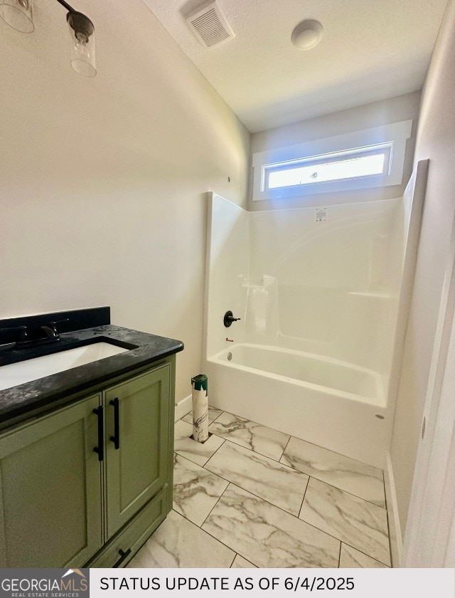 107 Tilden Way, Perry, GA 31069 - bathroom featuring vanity, marble look tiles, and shower / tub combination