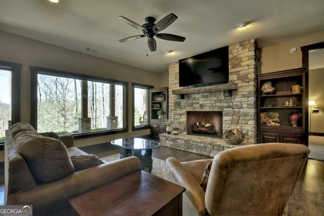living room with wood finished floors, a fireplace, and ceiling fan