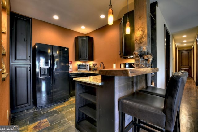 kitchen with open shelves, a kitchen breakfast bar, a peninsula, black refrigerator with ice dispenser, and hanging light fixtures
