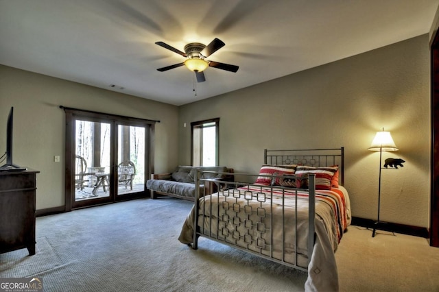 carpeted bedroom with baseboards, access to exterior, visible vents, and a ceiling fan