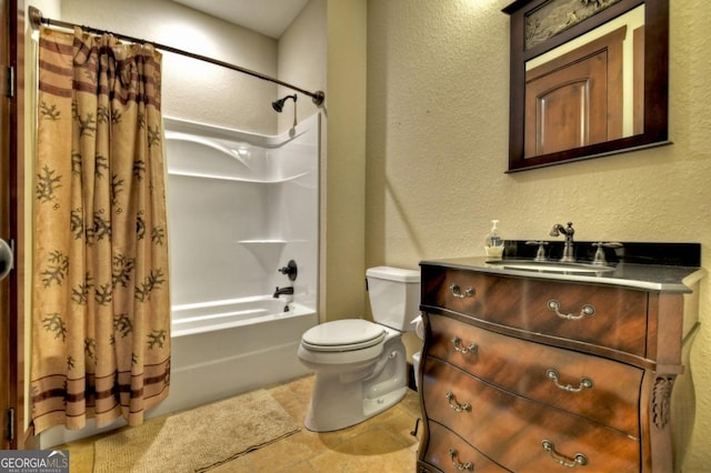 bathroom featuring tile patterned flooring, vanity, toilet, a textured wall, and shower / bath combo with shower curtain