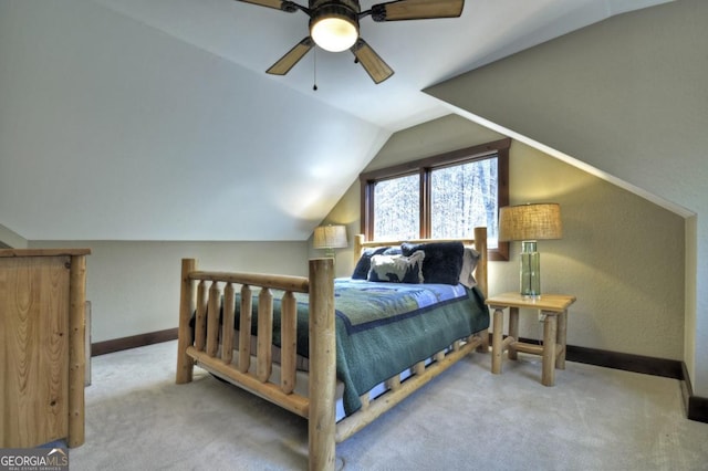 carpeted bedroom featuring baseboards, vaulted ceiling, and ceiling fan