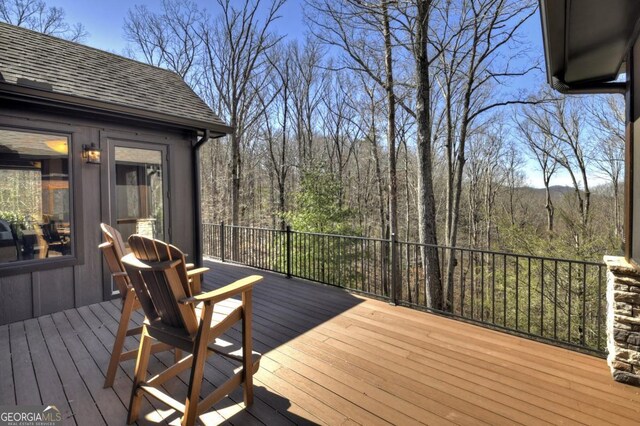 deck featuring a view of trees