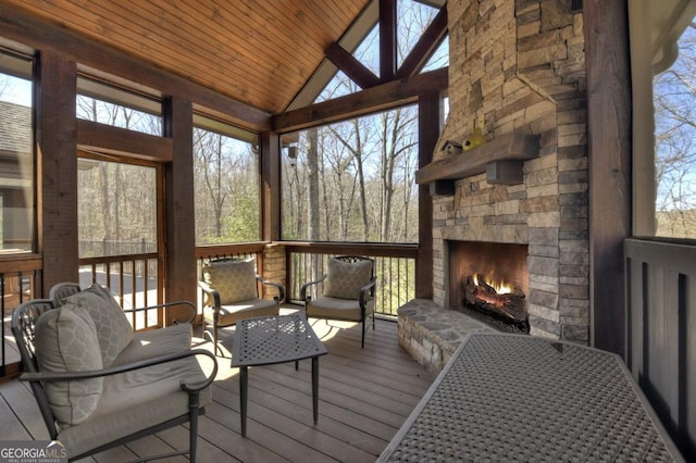 sunroom / solarium featuring an outdoor living space with a fireplace