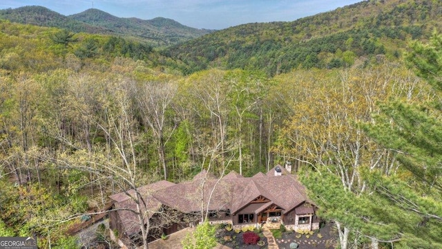 bird's eye view featuring a wooded view and a mountain view