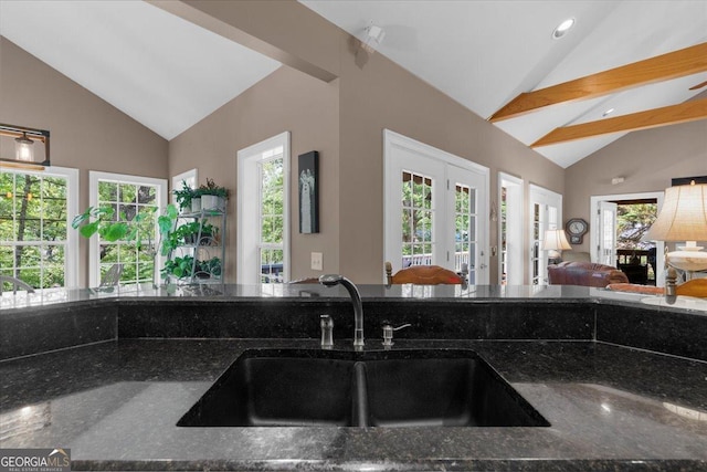 kitchen featuring a sink, french doors, open floor plan, and lofted ceiling