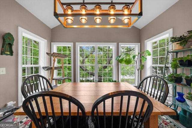 dining area featuring vaulted ceiling