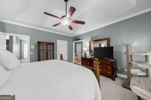 bedroom featuring crown molding, baseboards, ceiling fan, and carpet flooring