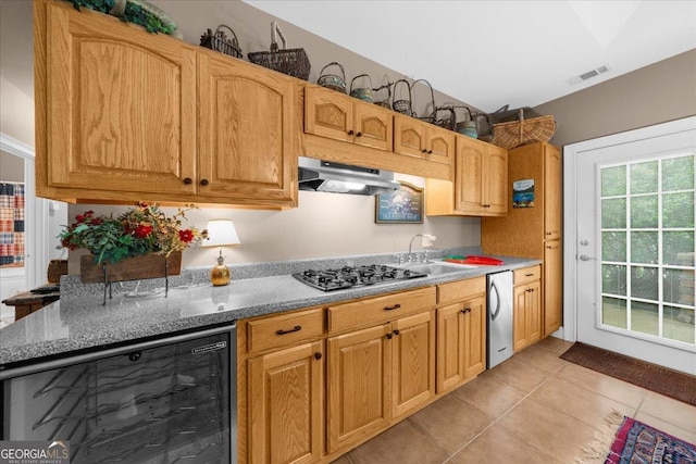 kitchen featuring visible vents, wine cooler, light tile patterned flooring, extractor fan, and gas cooktop