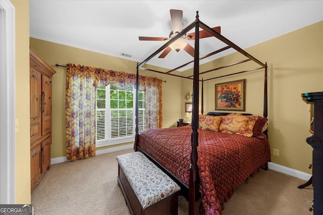 carpeted bedroom with visible vents, baseboards, and ceiling fan